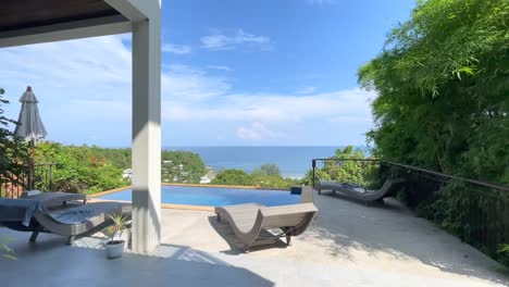 serene ko samui patio with infinity pool, curved lounge chairs, umbrella, lush greenery under a partly cloudy sky and vibrant hues, capturing a tranquil tropical escape