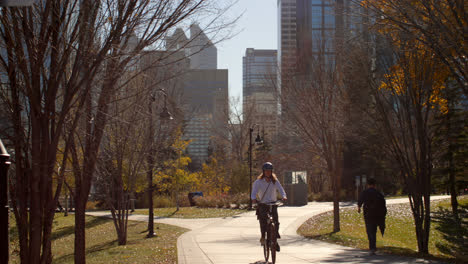 front view of young caucasian man riding bicycle in the park 4k