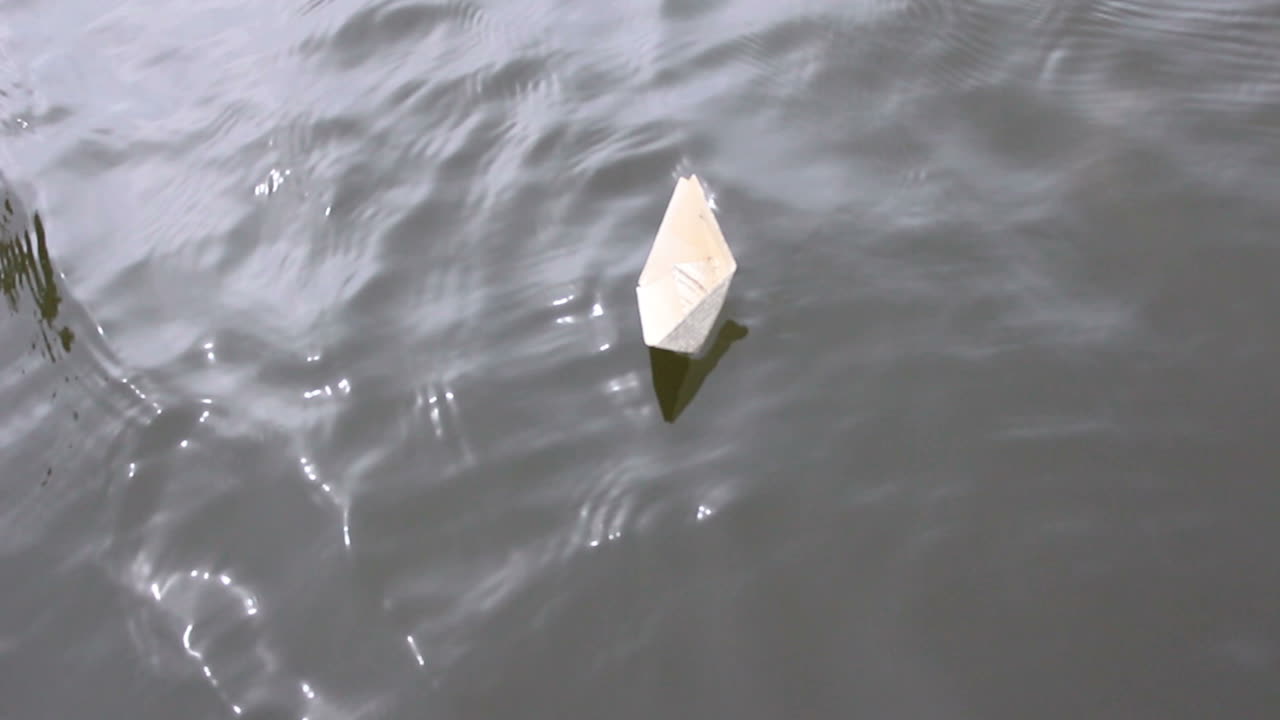 Active Leisure For Children. Boy play in paper ship in water puddel