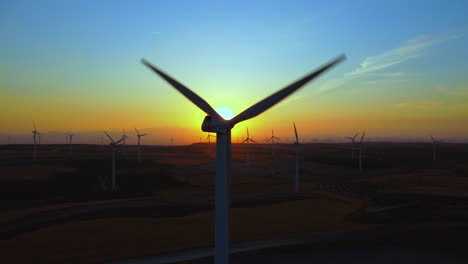 aerial view of wind turbines at sunset