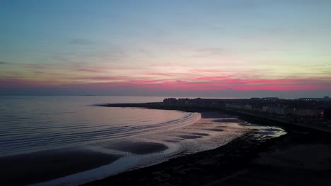 silhouetted red skye beach | drone shot