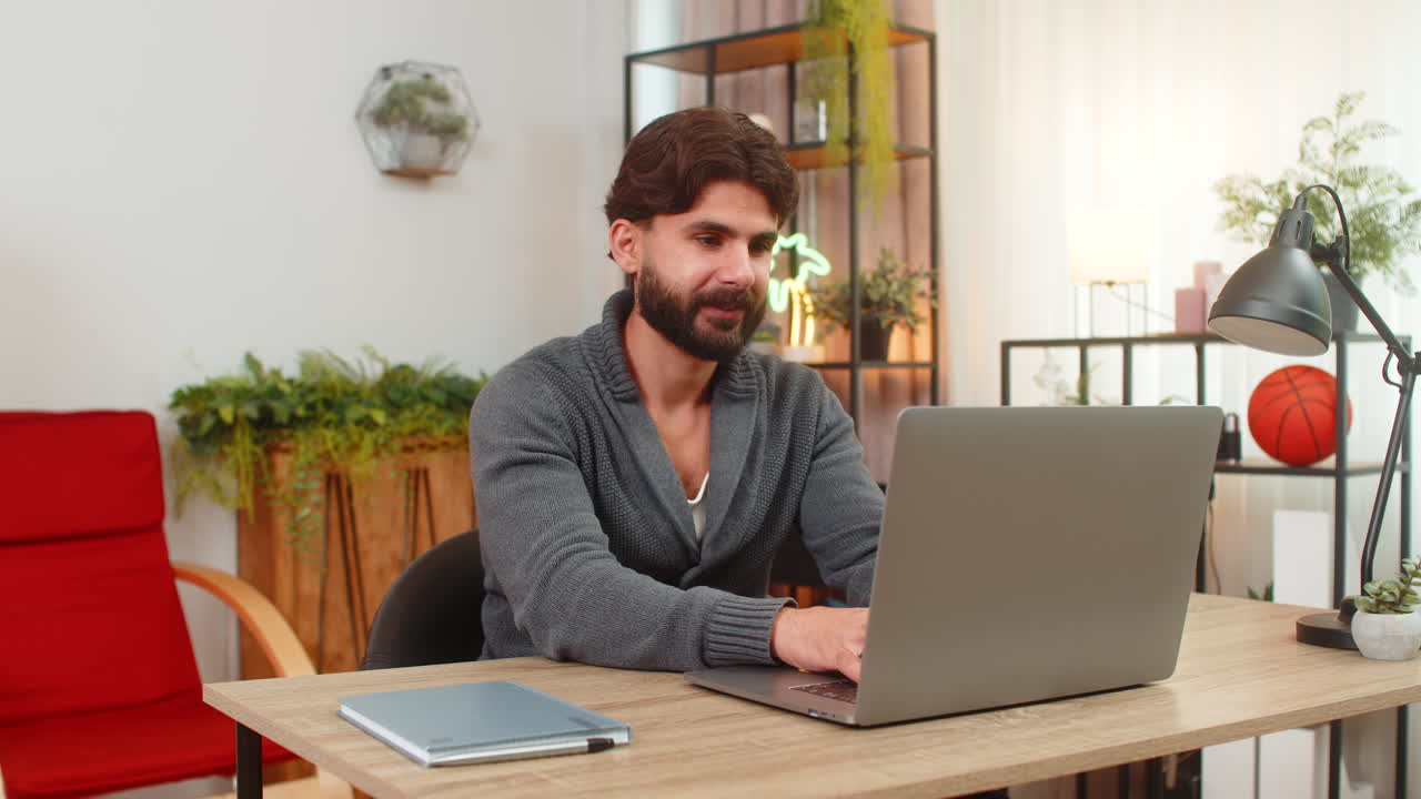 Indian man completes contract on laptop adds digital signature breathes relief shows approval sign