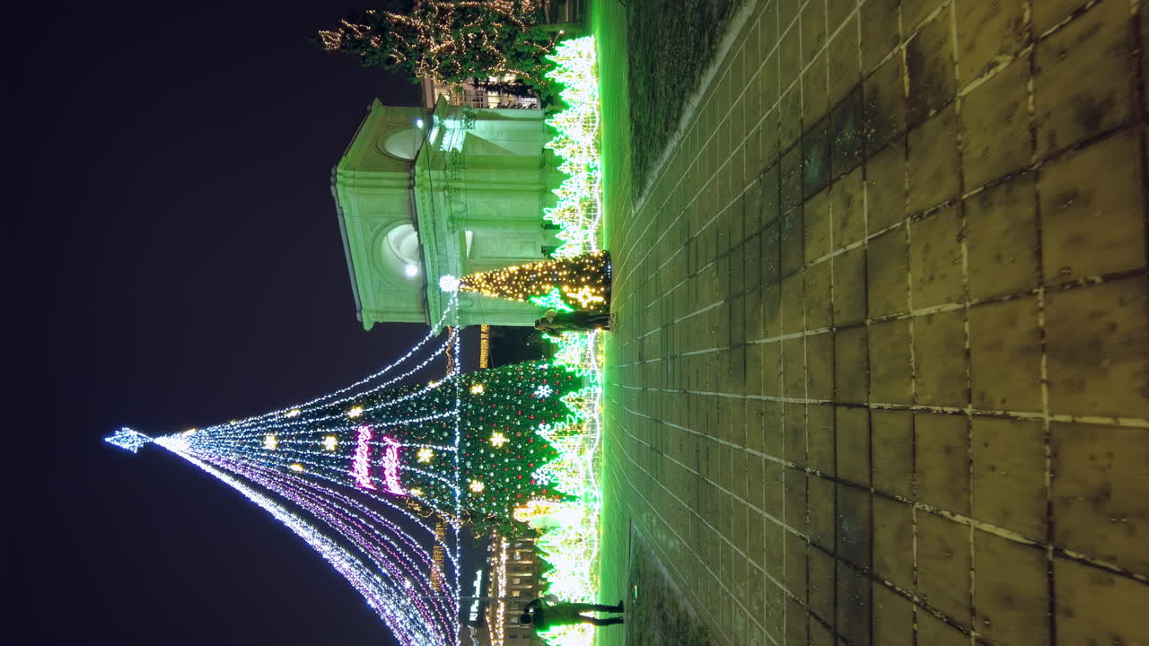 Chisinau, Moldova - December 20, 2021: Bright lights illuminate the park, creating a festive atmosphere during winter. Colorful decorations fill the trees and walkways, inviting visitors to admire the beauty