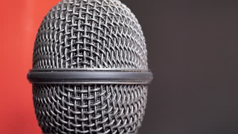 Extreme-closeup-of-old-dirty-stereo-microphone-head,-spinning