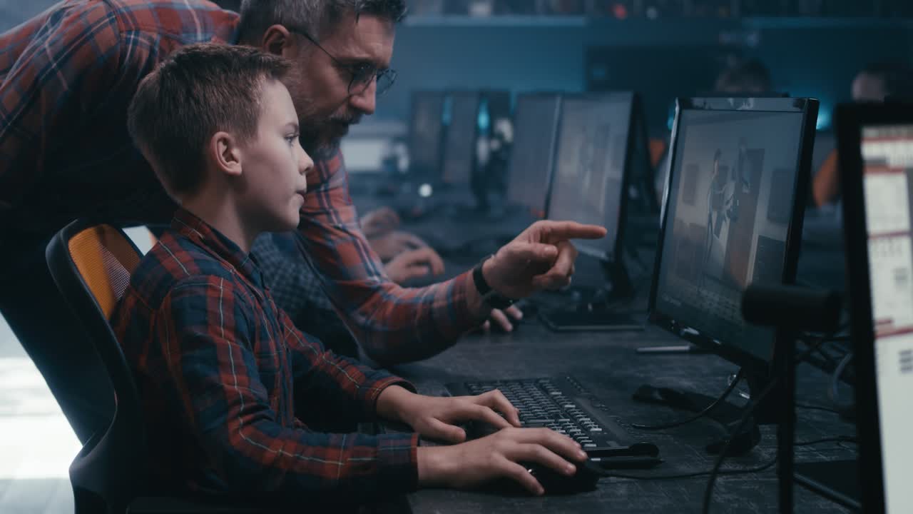 Student learning graphic design with a teacher in a computer lab