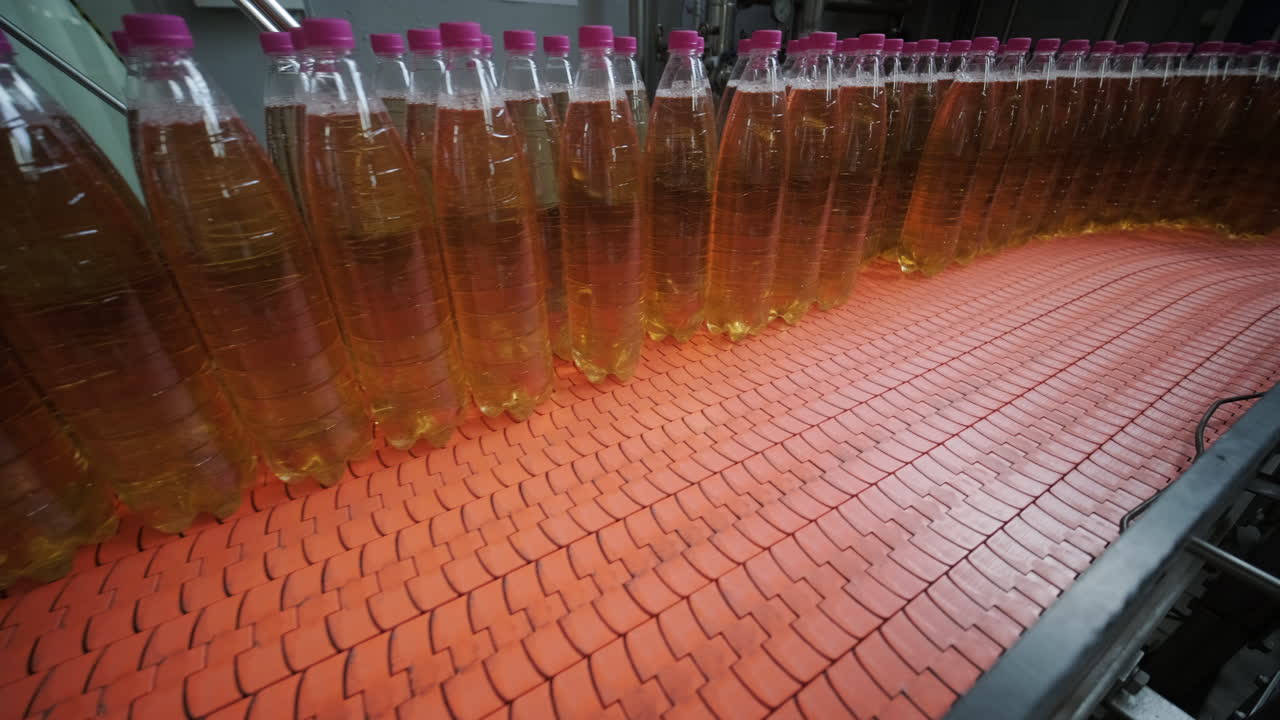 Plastic Bottles on a Conveyor Belt in a Beverage Production Facility