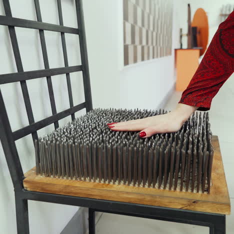 ?hair with metal spikes on the seat. ?oncept of physics. museum of science