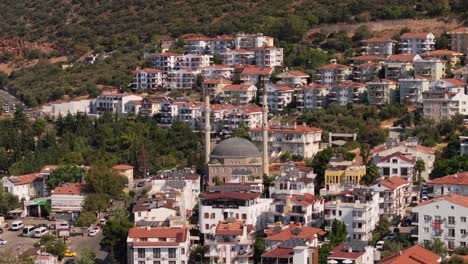 aerial telephoto dolly to mosque of kas, antalya, turkey, featuring the scenic town with red tiled roofs and white walls