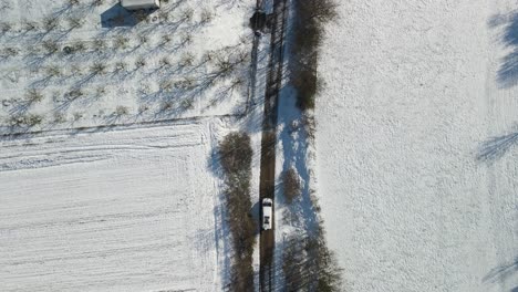 aerial view of a van stoping on a narrow path in the countryside on a beautiful winter day, dalmatia, croatia