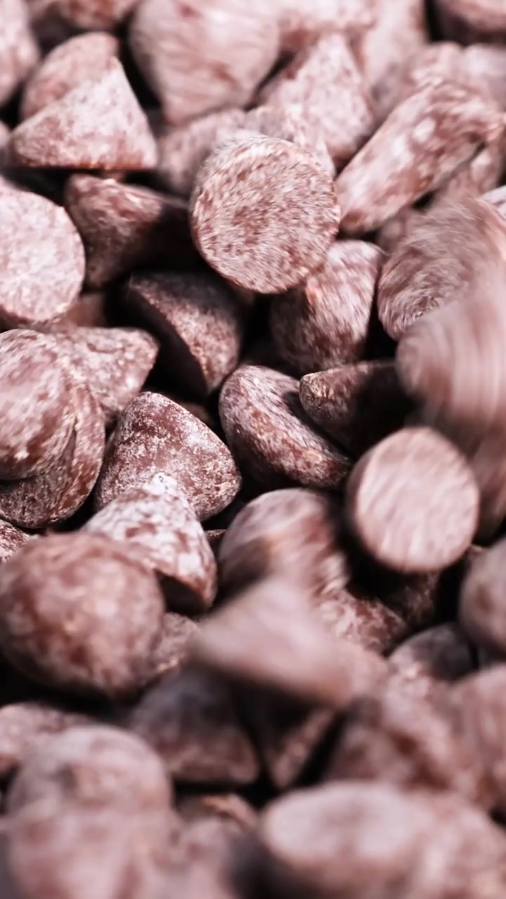 Chocolate chips falling and settling in a pile