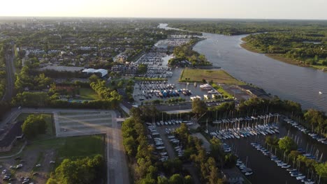 Aerial-forward-over-San-Isidro-Yacht-club-along-Rio-de-la-Plata-river-at-sunset,-Buenos-Aires-in-Argentina