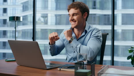 young businessman rejoicing profit growth closeup. man gesturing yes alone
