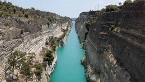 turquoise blue water of corinth canal with steep cliffs on a sunny day in greece