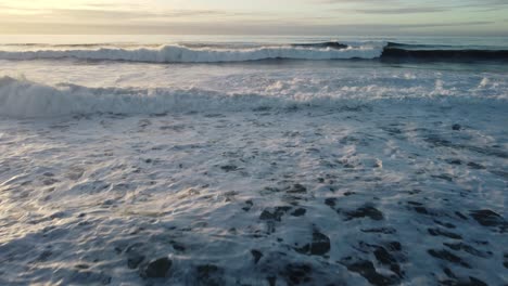 close up of the waves along pescadero state beach taken from a drone