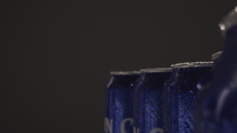 close up or macro shot of condensation droplets on takeaway cans of cold beer or soft drinks against black background with copy space 1