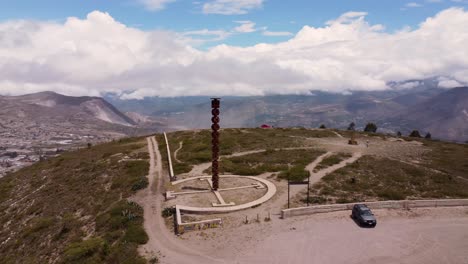 Spinning-aerial-around-the-Cerro-Catequilla,-Middle-of-the-earth-in-Ecuador
