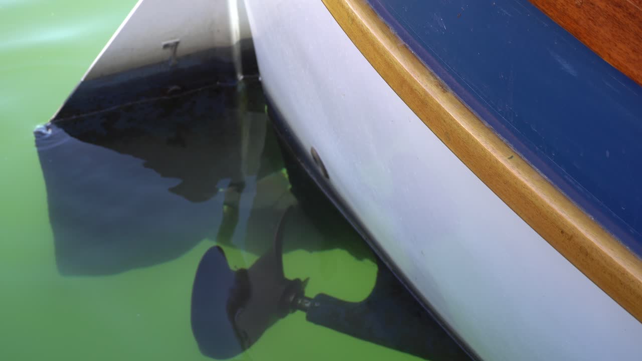 The view of an underwater propeller from a boat that is parking in a marina