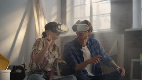 focused family making layout in vr glasses. couple using headsets indoors.