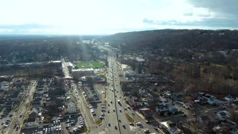 interstate highway leading through small town of plainfield, aerial drone view