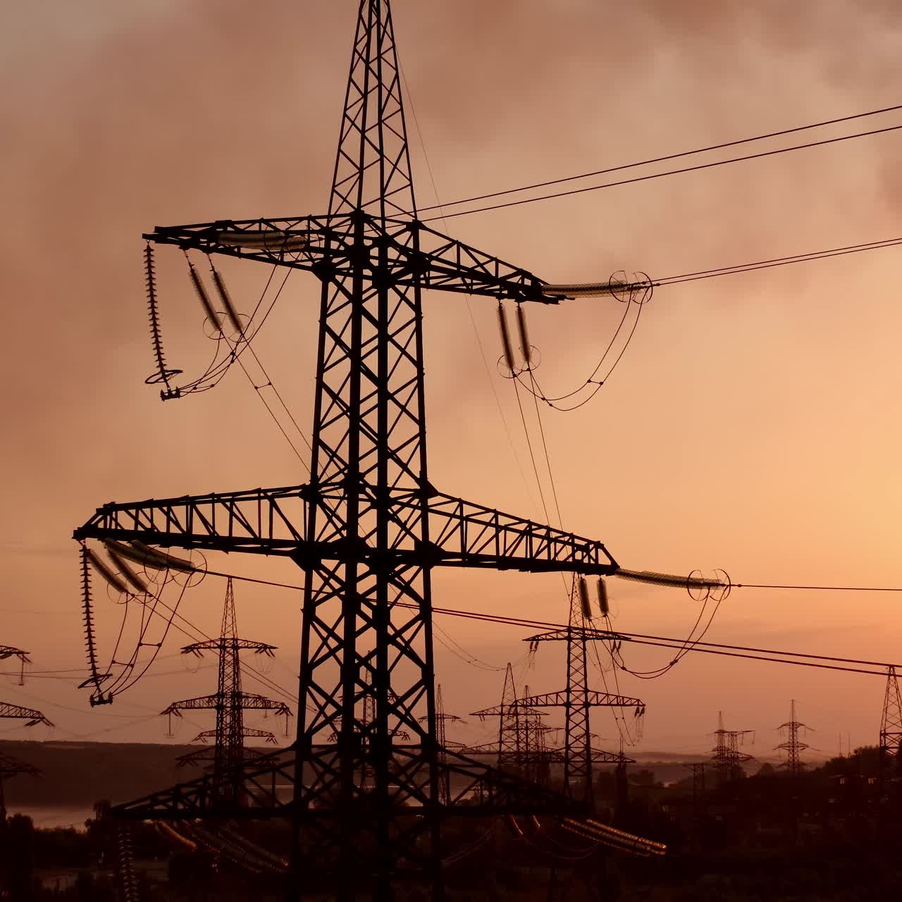 Electricity tower with wires at sunset. Tall pylon carries wires that transport electric power from generating stations to electrical substations against the evening sky