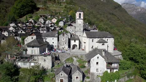 aerial-view-of-medieval-town-village-of-Corippo-in-the-mountains,-small-mountain-village-in-Ticino-Corippo,-Verzasca-valley,-Switzerland