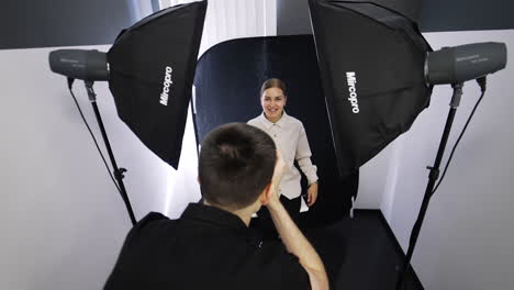 male dentist in black uniform taking picture of a smiling female patient. doctor's portfolio replenishment.
