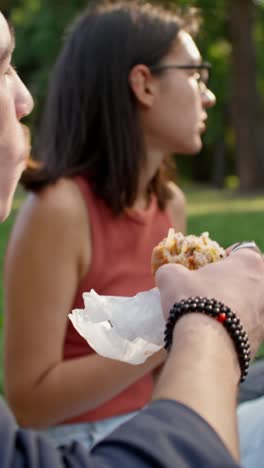 friends enjoying a picnic lunch in the park