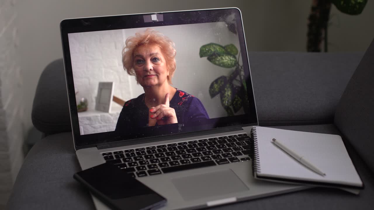 Head shot aged woman qualified psychologist looks at cam during psychological support session on-line counselling with client over telecommunication app. Chat via teleconference with relatives concept