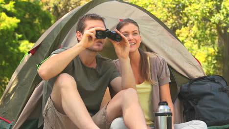 man looking through binoculars