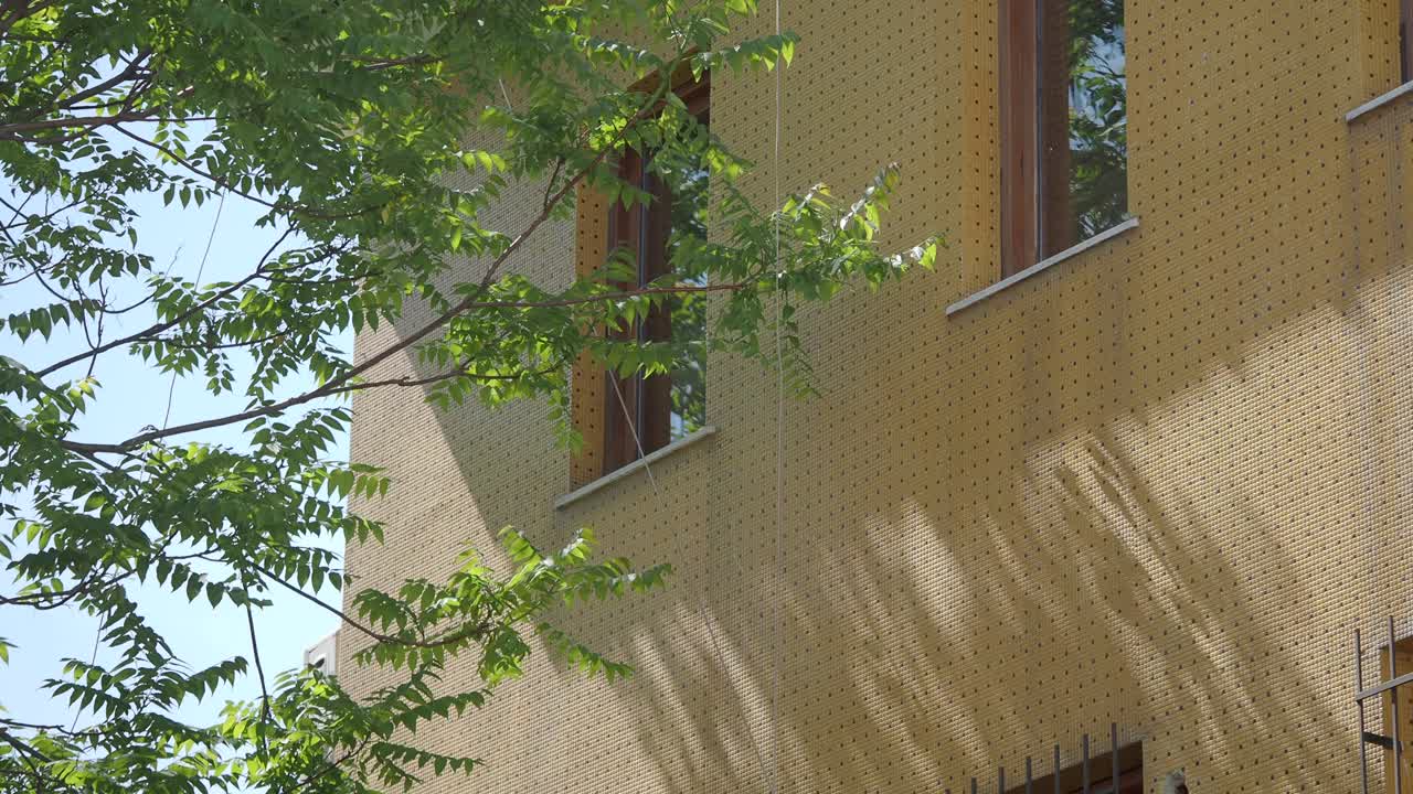 Building with Yellow Facade and Trees