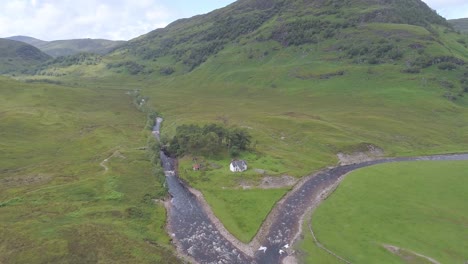 aerial push in over remote cottage near loch treig on the abhainn rath rannoch moor