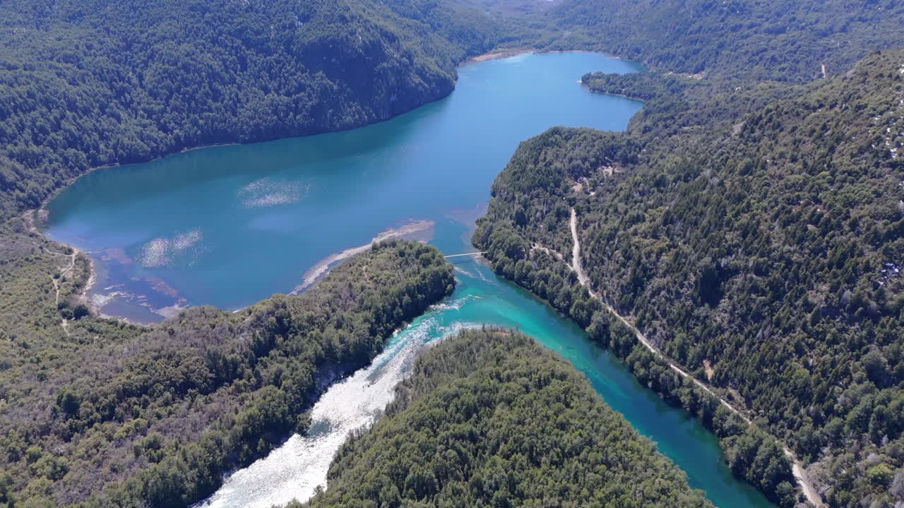 Aerial shot of Lago Verde, Los Alerces National Park. A lake with its tributaries among the pine covered hills.