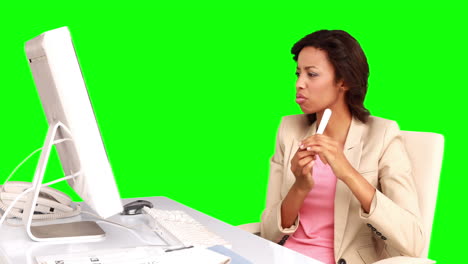 Businesswoman-filing-her-nails-at-her-desk