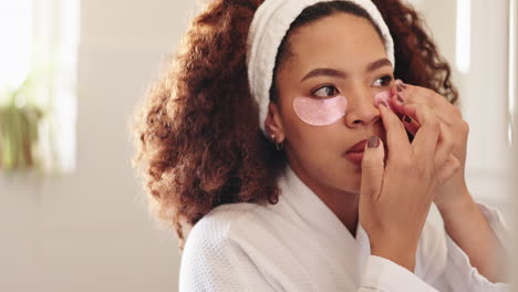 woman applying eye patches