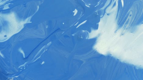 closeup swirl and movement of blue acrylic color