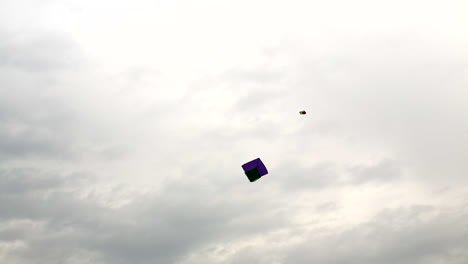 A-bird-group-flying-with-Kites-in-the-cloudy-sky,-The-traditional-hand-made-kites-in-Pakistan-and-India