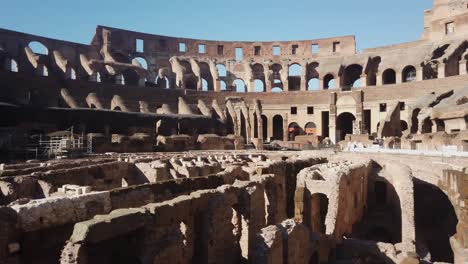 pan r across interior ruins of the roman colosseum in rome, italy