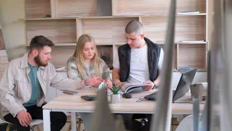 a group in a room in the building sharing a meeting at the table