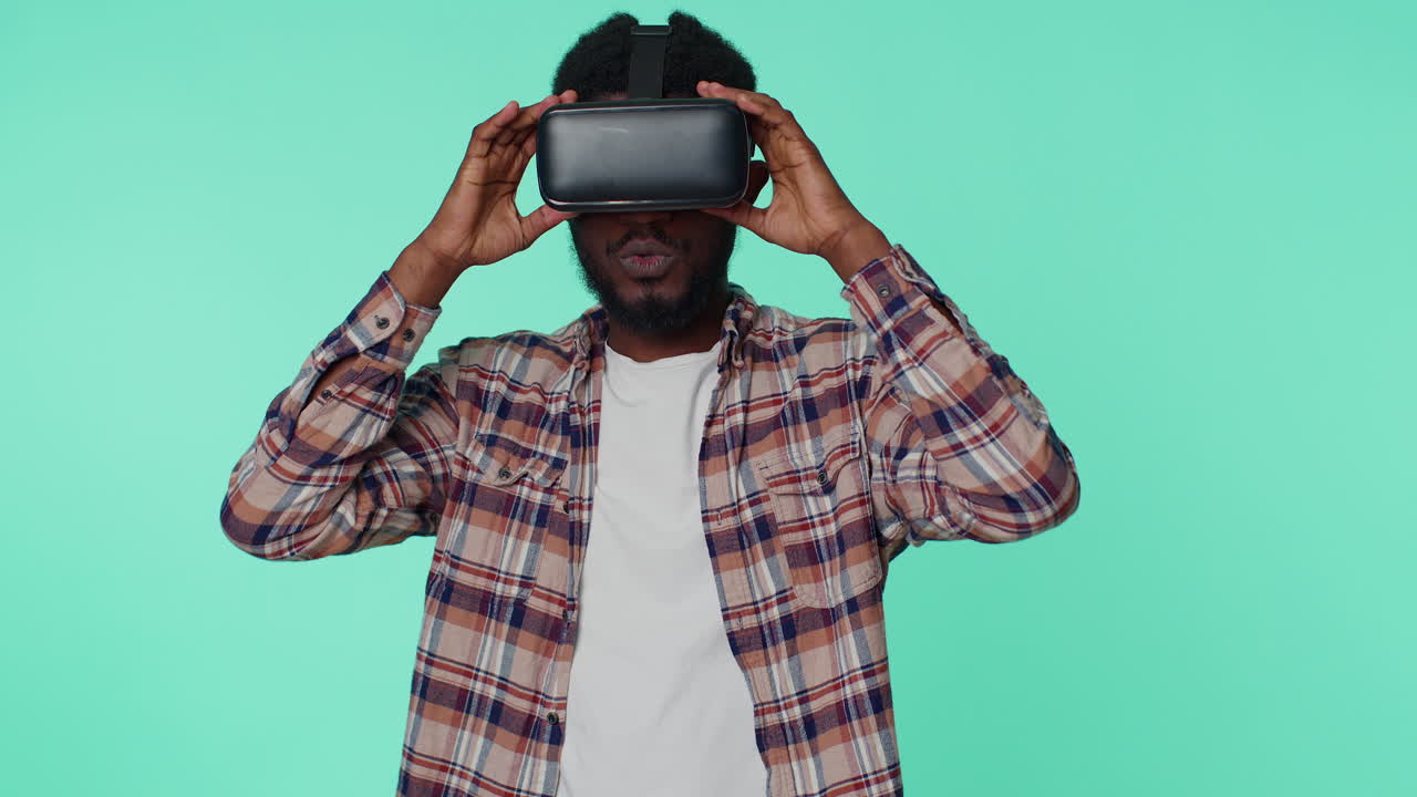 Man using virtual reality futuristic technology VR headset helmet to play simulation 3D video game