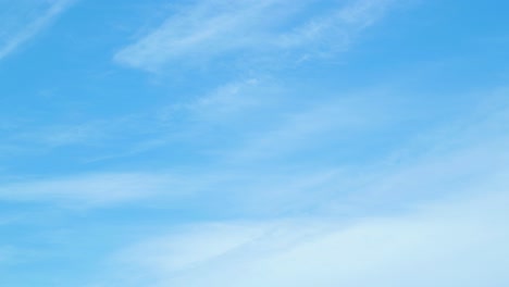 Slow-cloud-time-lapse-at-clear-weather-on-blue-sky,-medium-shot