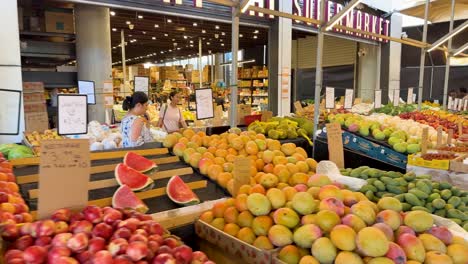 colorful produce displayed at bustling market stalls