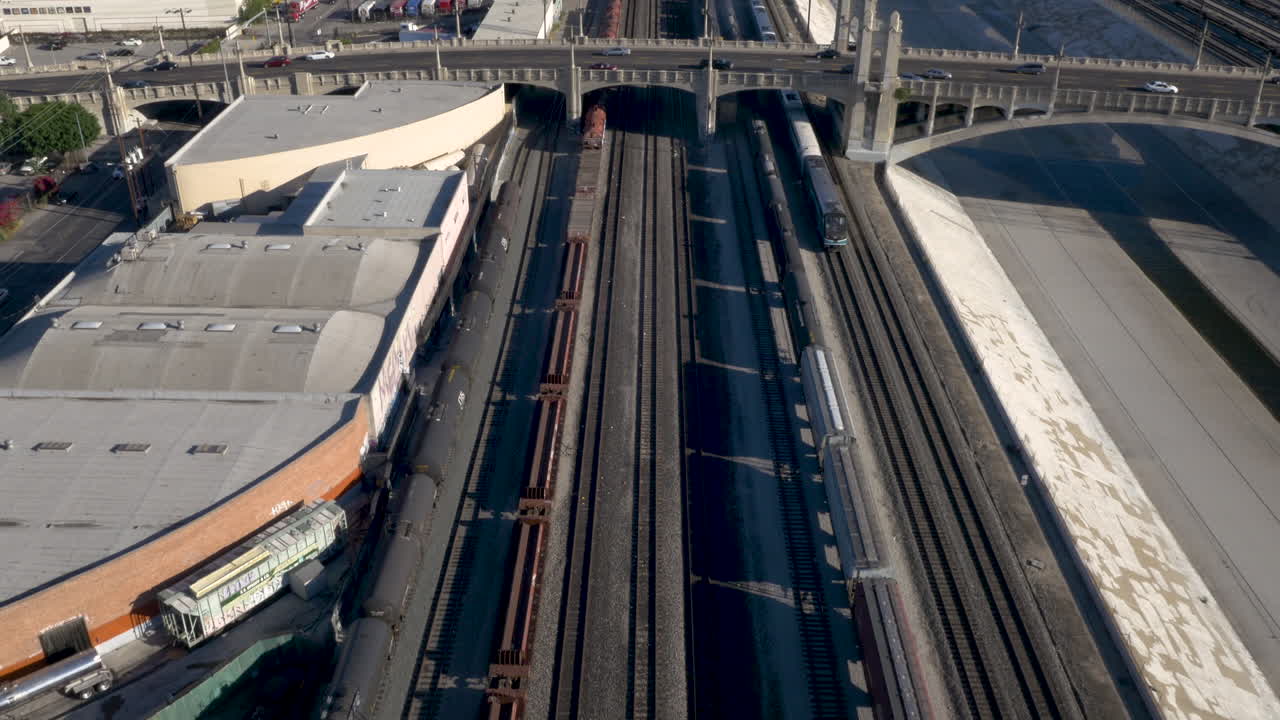 Aerial view of extensive train tracks, industrial areas, and urban infrastructure in a city