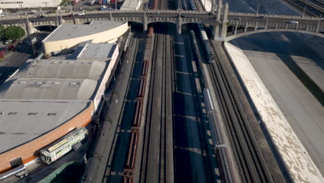 aerial view of extensive train tracks, industrial areas, and urban infrastructure in a city