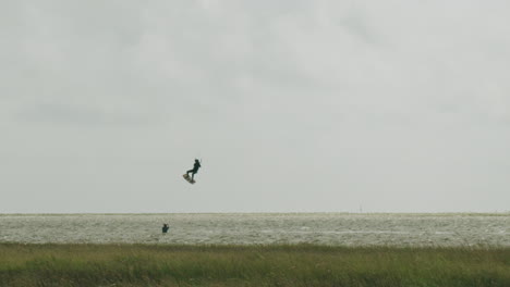 Wide-shot-of-a-kite-surfer-performing-a-trick-with-his-kite