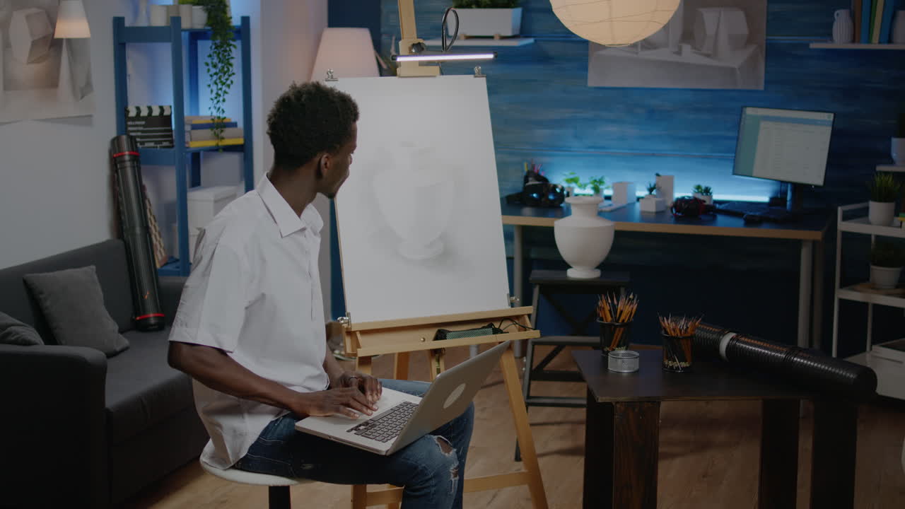Man of african american ethnicity working on vase drawing