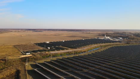 aerial view of large sustainable electrical power plant with rows of solar photovoltaic panels for producing clean ecological electric energy. renewable electricity with zero emission concept