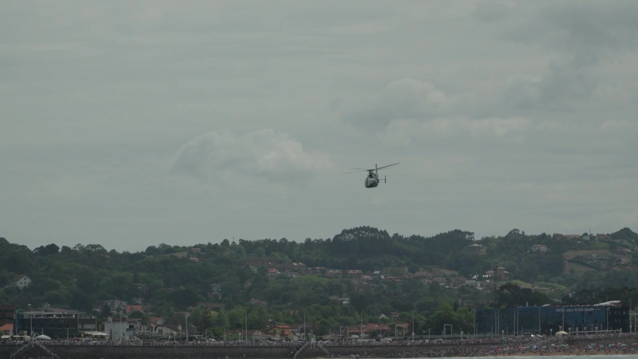 Guardia Civil helicopter flying low along the coast at Gijon Air Show