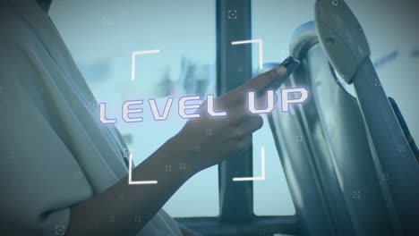 animation of level up text over caucasian woman using smartphone