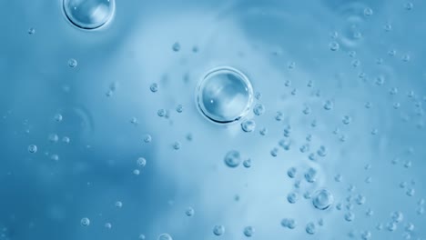 Oxygen-bubbles-in-water-on-a-blue-abstract-background-on-super-slow-motion.