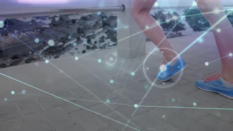 Animation-of-network-lines-connecting-dots,-caucasian-woman-doing-stretch-exercise-on-pier-at-beach